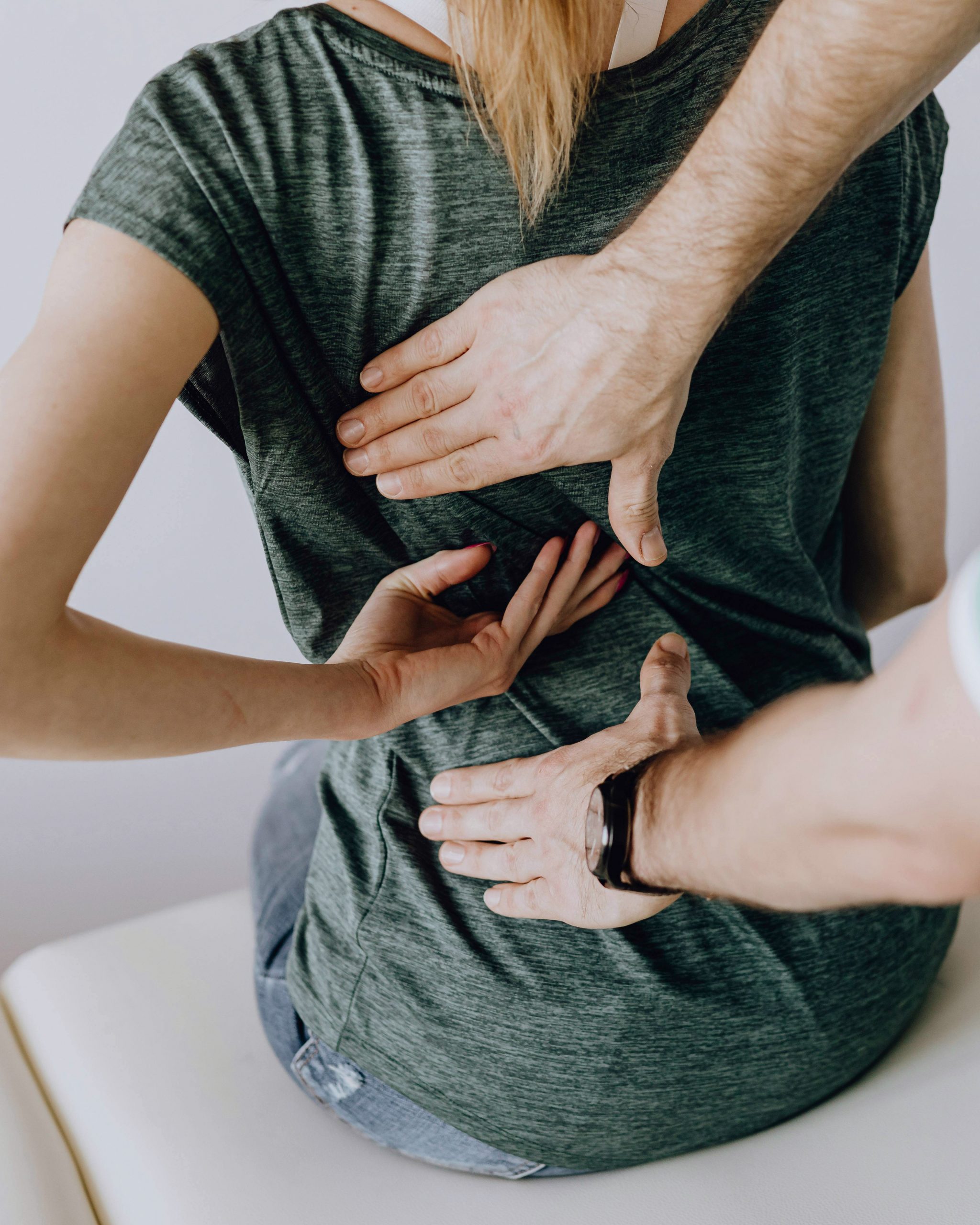A woman holding her back.