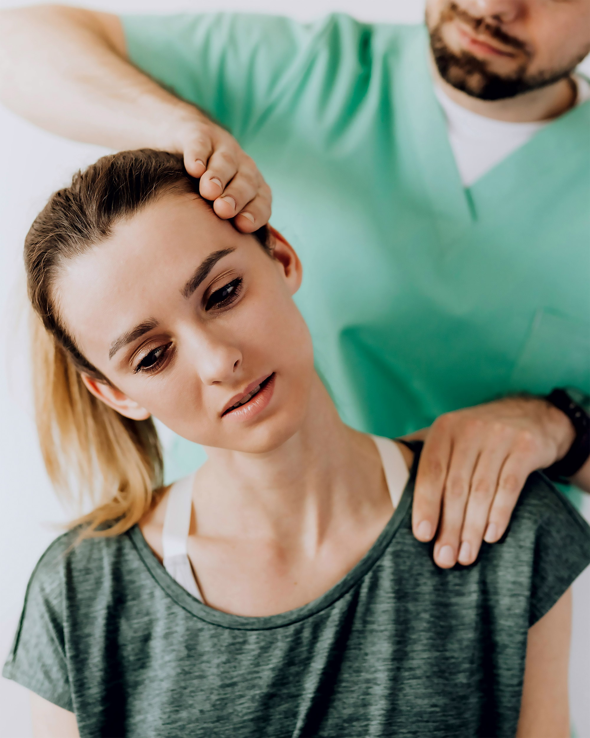 A physical therapist aiding a patient in neck techniques. 