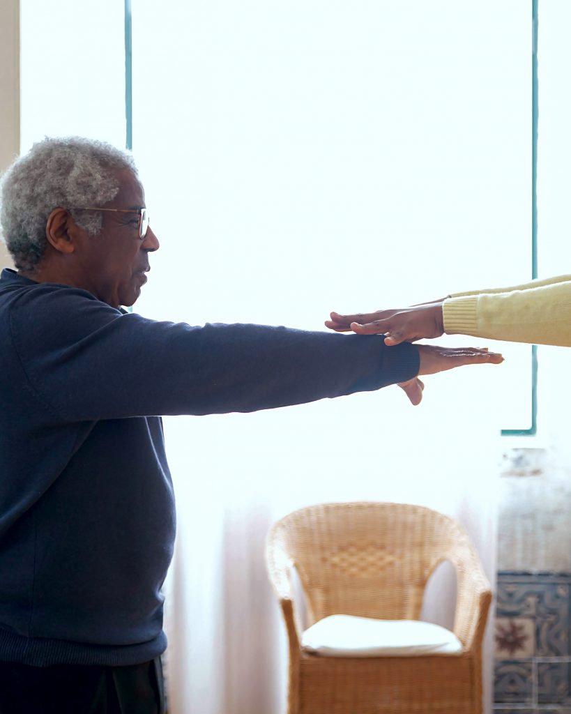 A man raising his arms before him. 
