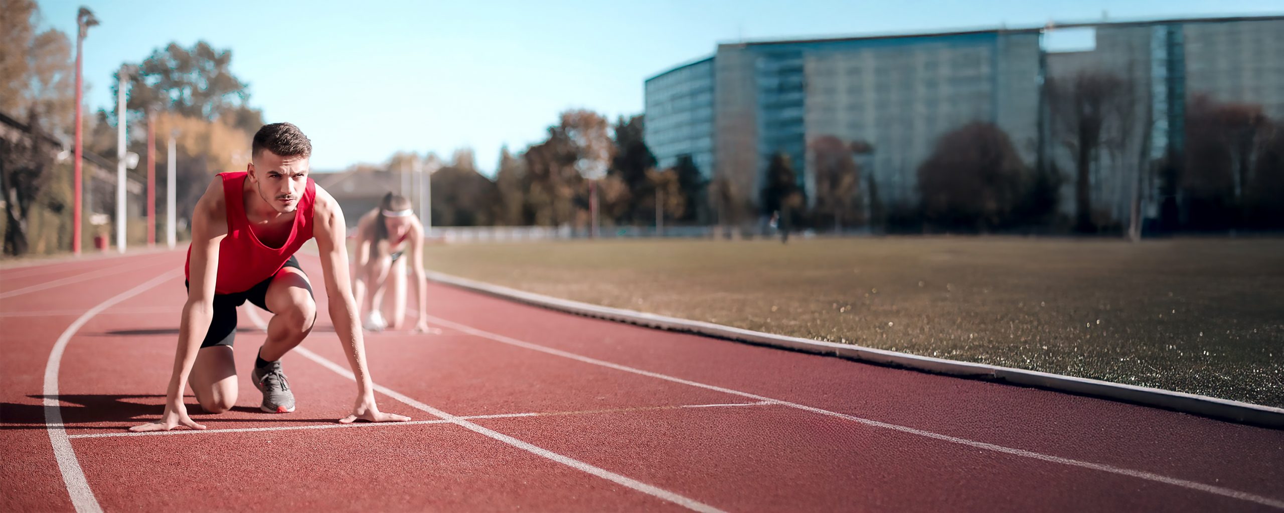 A man poised and ready to start a race. 